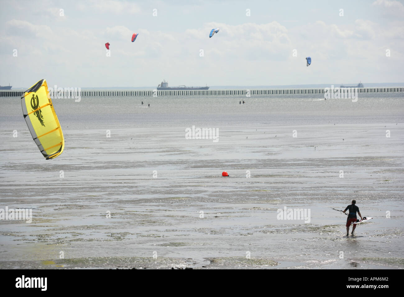 A kite boarding enthusiast making for deeper water Shoebury, Southend on Sea, Essex, England, UK. Stock Photo