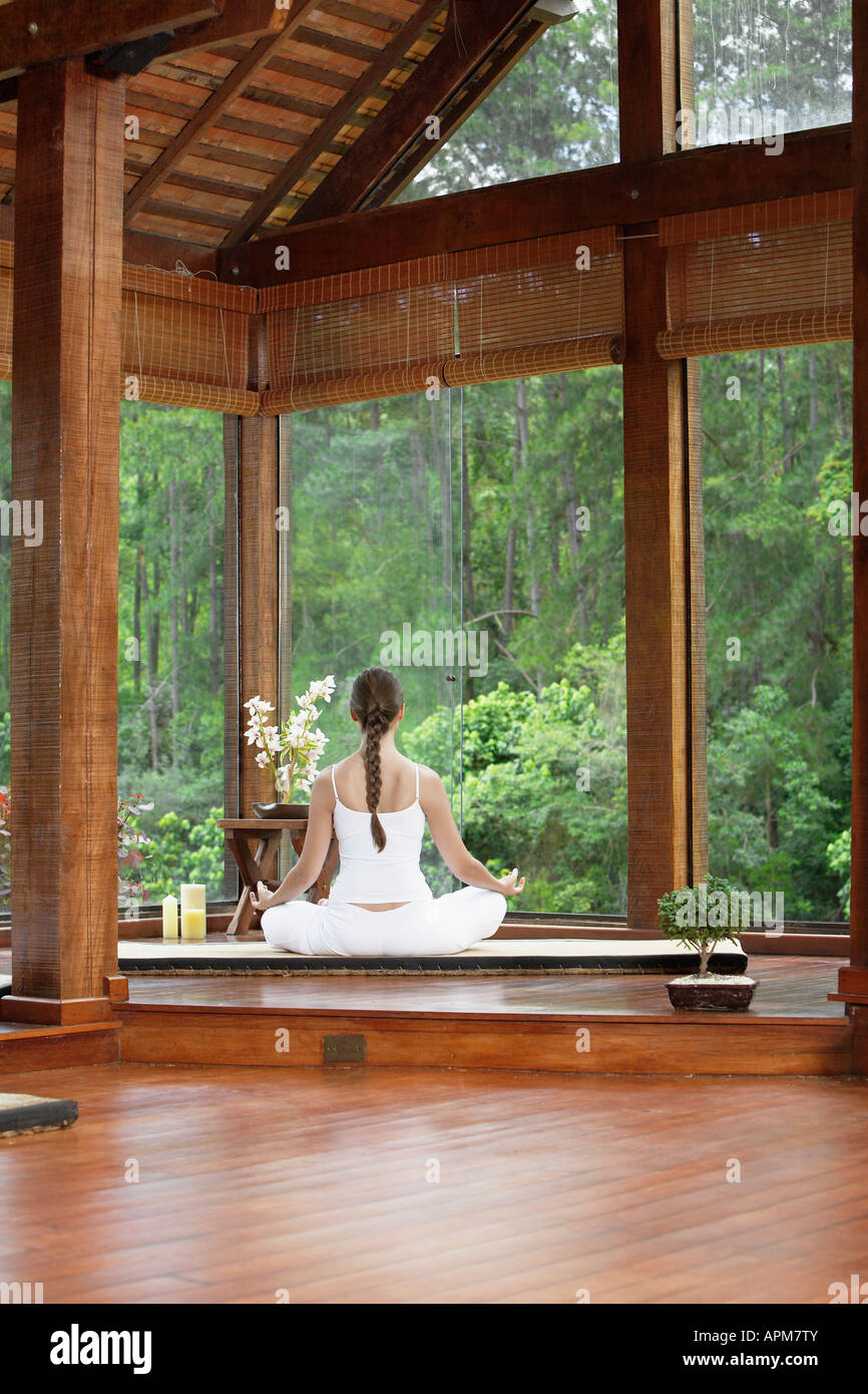 Woman meditating on tatami near windows, rear view Stock Photo - Alamy