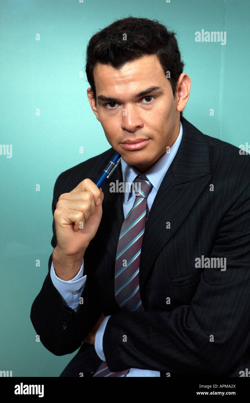 Portrait of businessman holding a pen Stock Photo - Alamy