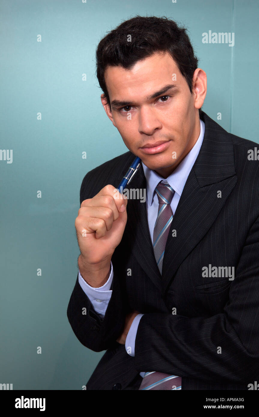 Portrait of businessman holding a pen Stock Photo - Alamy