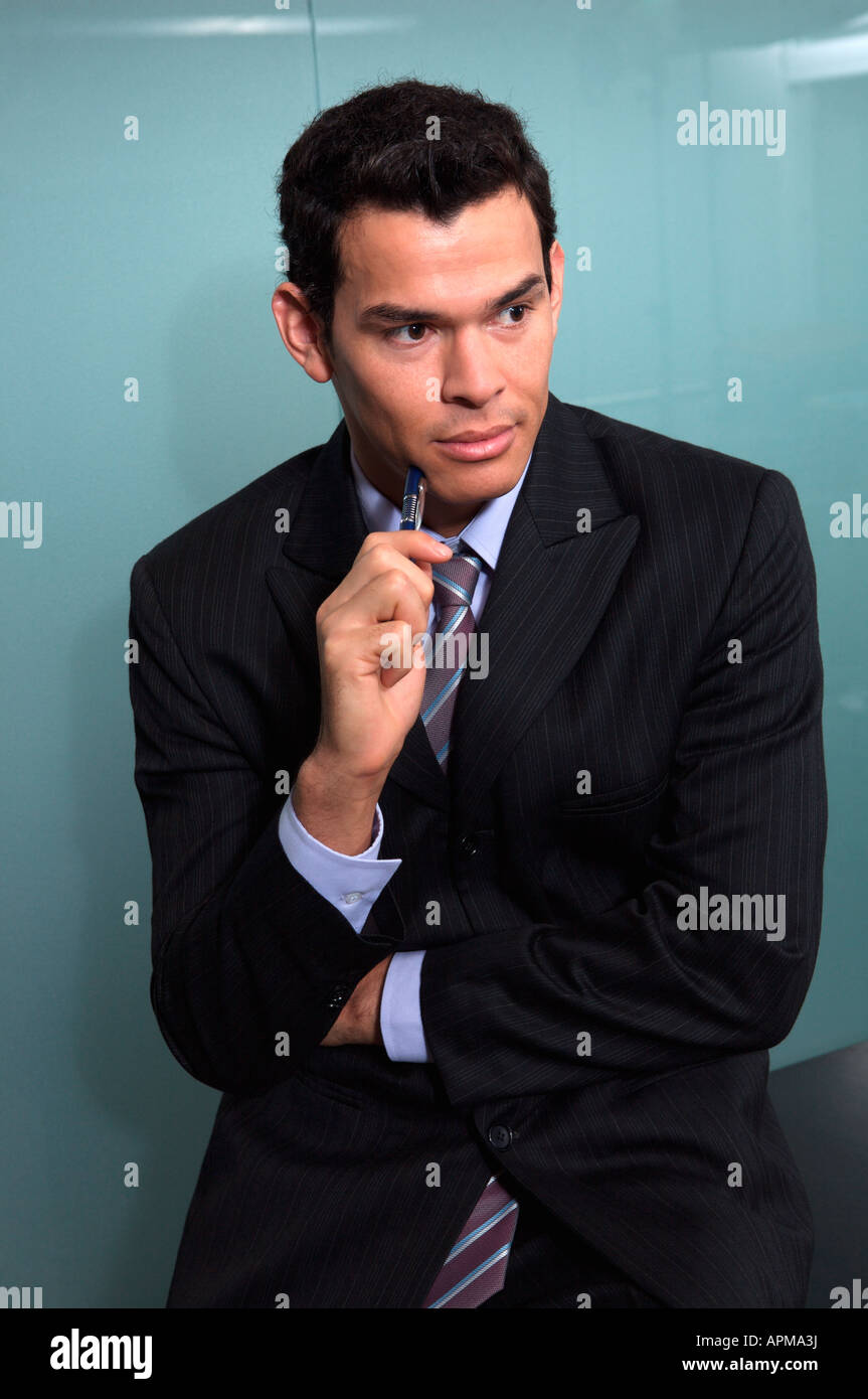 Portrait of businessman holding a pen Stock Photo - Alamy