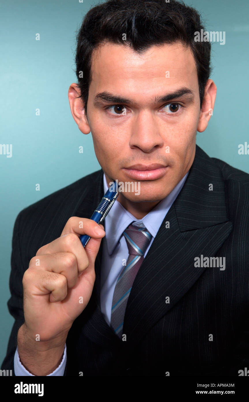 Portrait of businessman holding a pen Stock Photo - Alamy