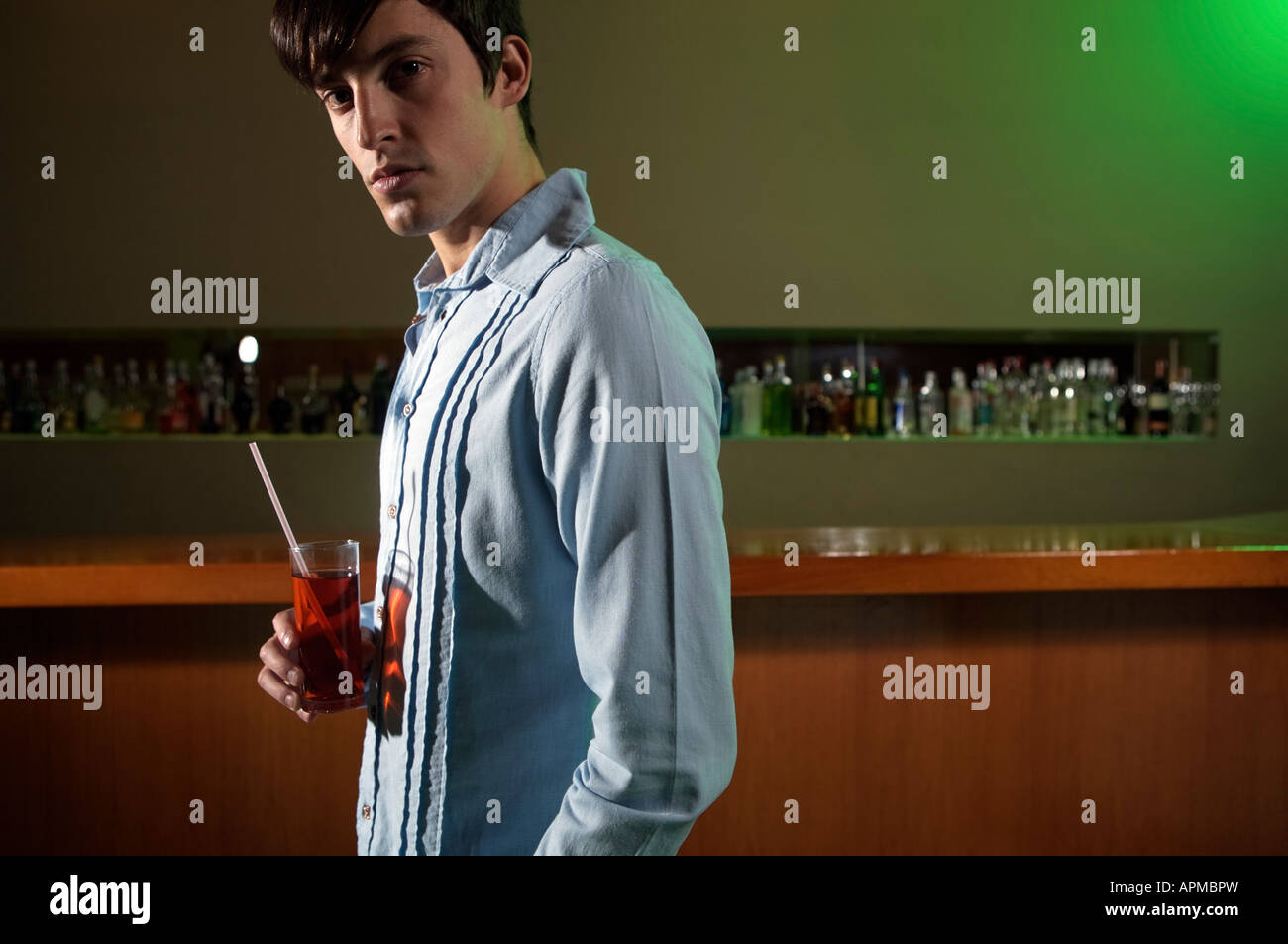 Man with a drink in a bar Stock Photo
