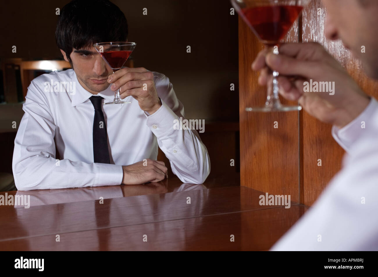 Man with a drink in a bar Stock Photo Alamy