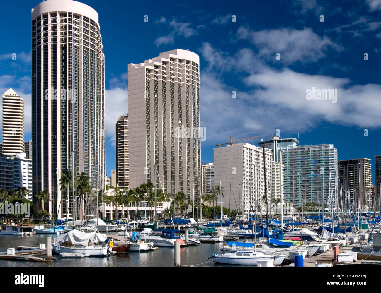 Two Hawaii Prince hotel towers and other hotels overlook masts at Ala Wai Boat Harbor Honolulu
