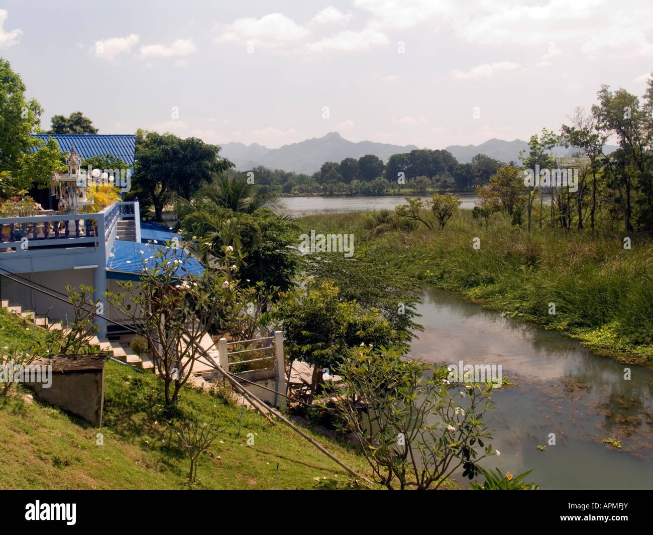 Many hotel and guest house properties back on to this River Kwai channel near the River Kwai bridge Kanchanaburi Thailand Stock Photo