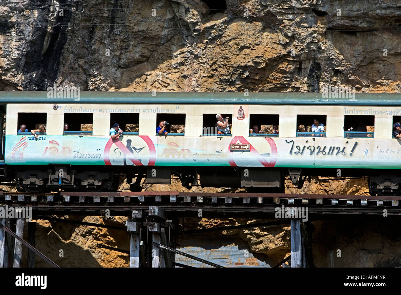 Passenger train on Krasae wooden trestle bridge Burma Railway Kanchanaburi Thailand Stock Photo