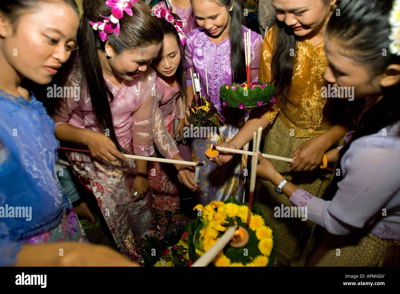 Young women light a float Loy Krathong Festival Jong Kham Lake Mae Hong Son Thailand Stock Photo