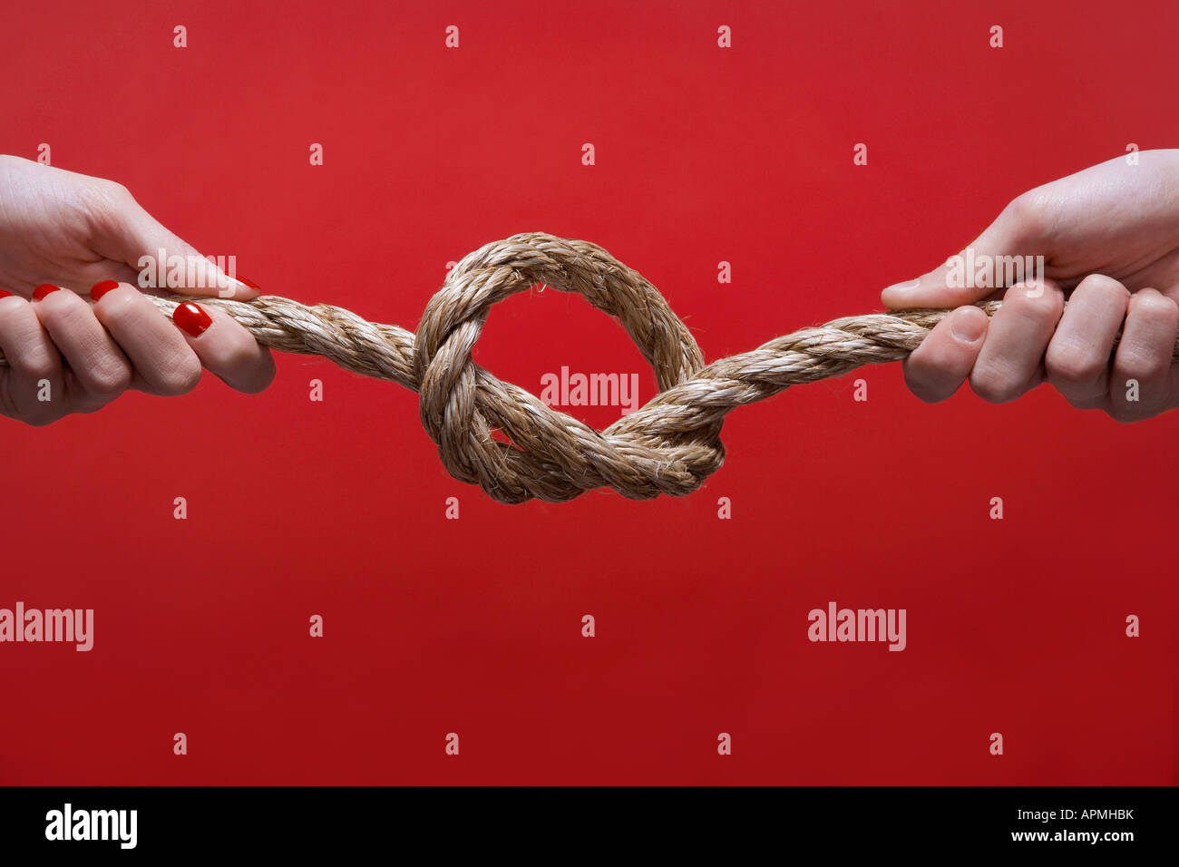 Two hands tying knot (closeup Stock Photo Alamy