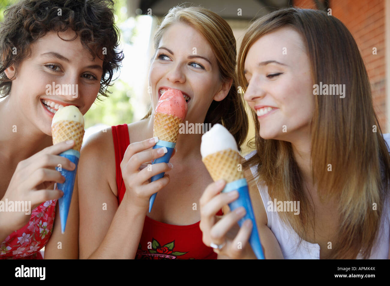 Three teenage girls eating ice creams Stock Photo Alamy