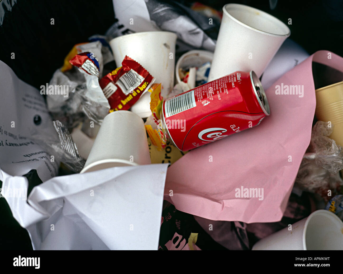 waste in a bin with a coke can on top Stock Photo Alamy