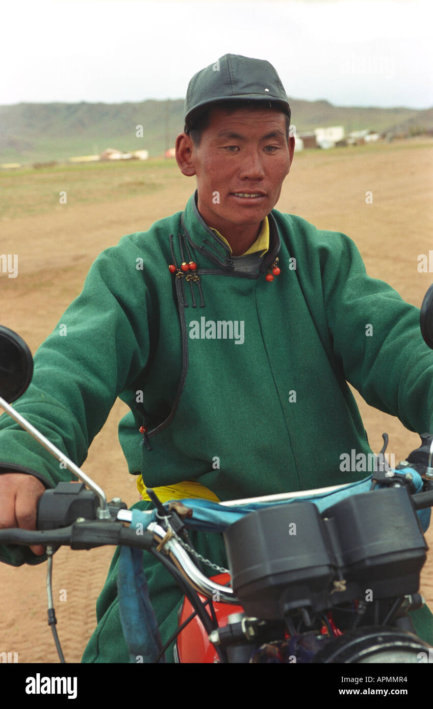 Man in national Mongolian clothes del on motorcycle. Numrug somon (village). Zavkhan aimag (province). Mongolia Stock Photo