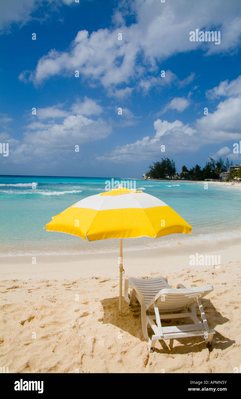 Beautiful yellow umbrella and chair in front of beautiful clear 
