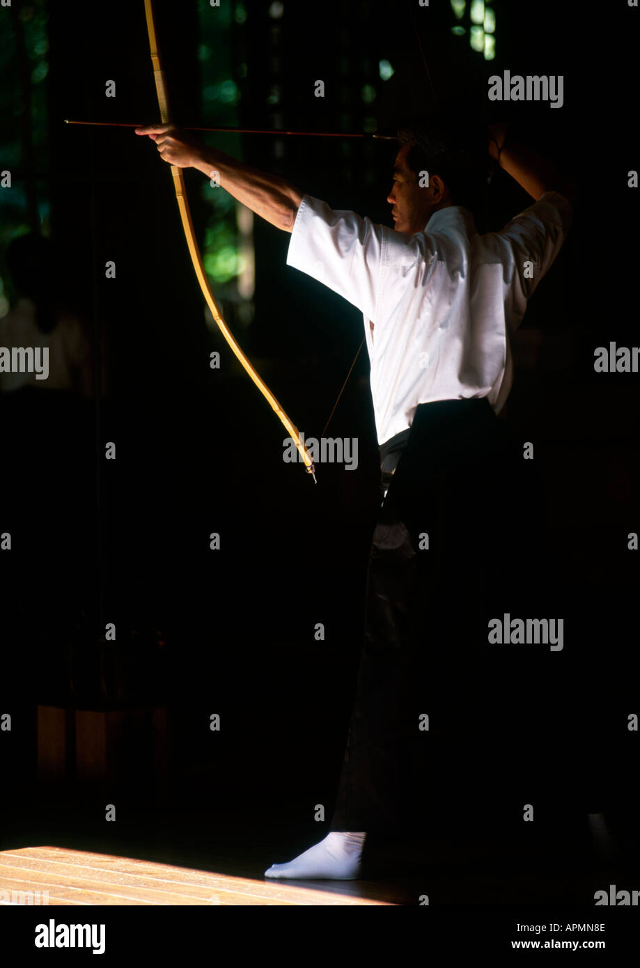 Kyudo archer practicing at an outdoors archery range in Japan Stock