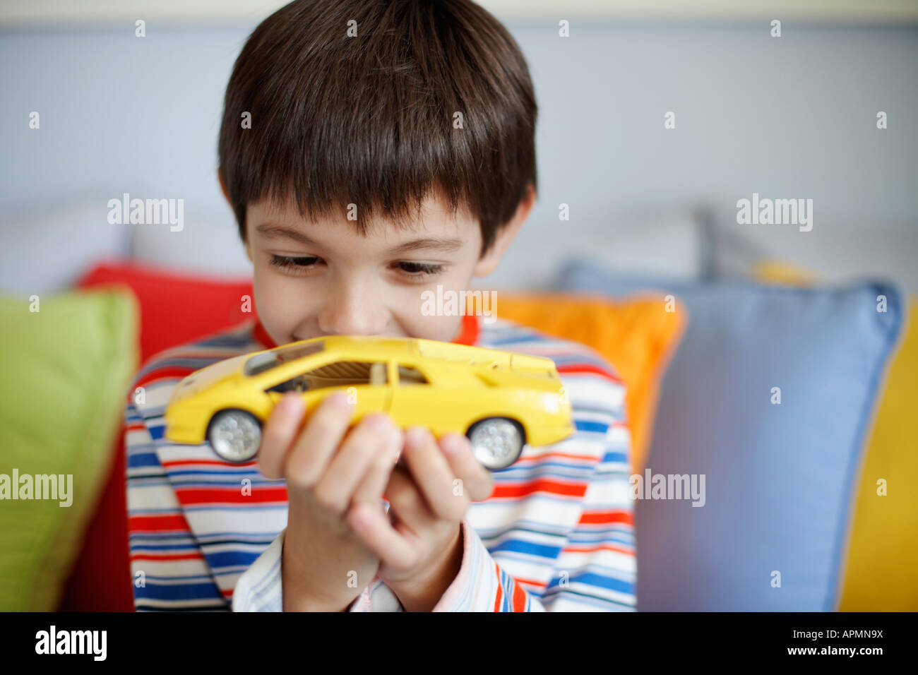 Boy playing with toy car Stock Photo - Alamy