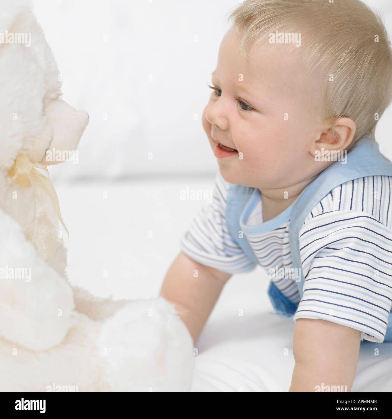 Baby boy (1-2) looking at teddy bear Stock Photo - Alamy