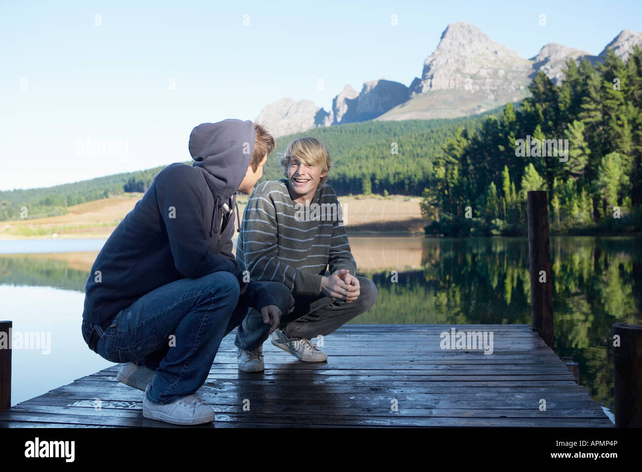 Two teenage boys on jetty, Cape Town, South Africa Stock Photo