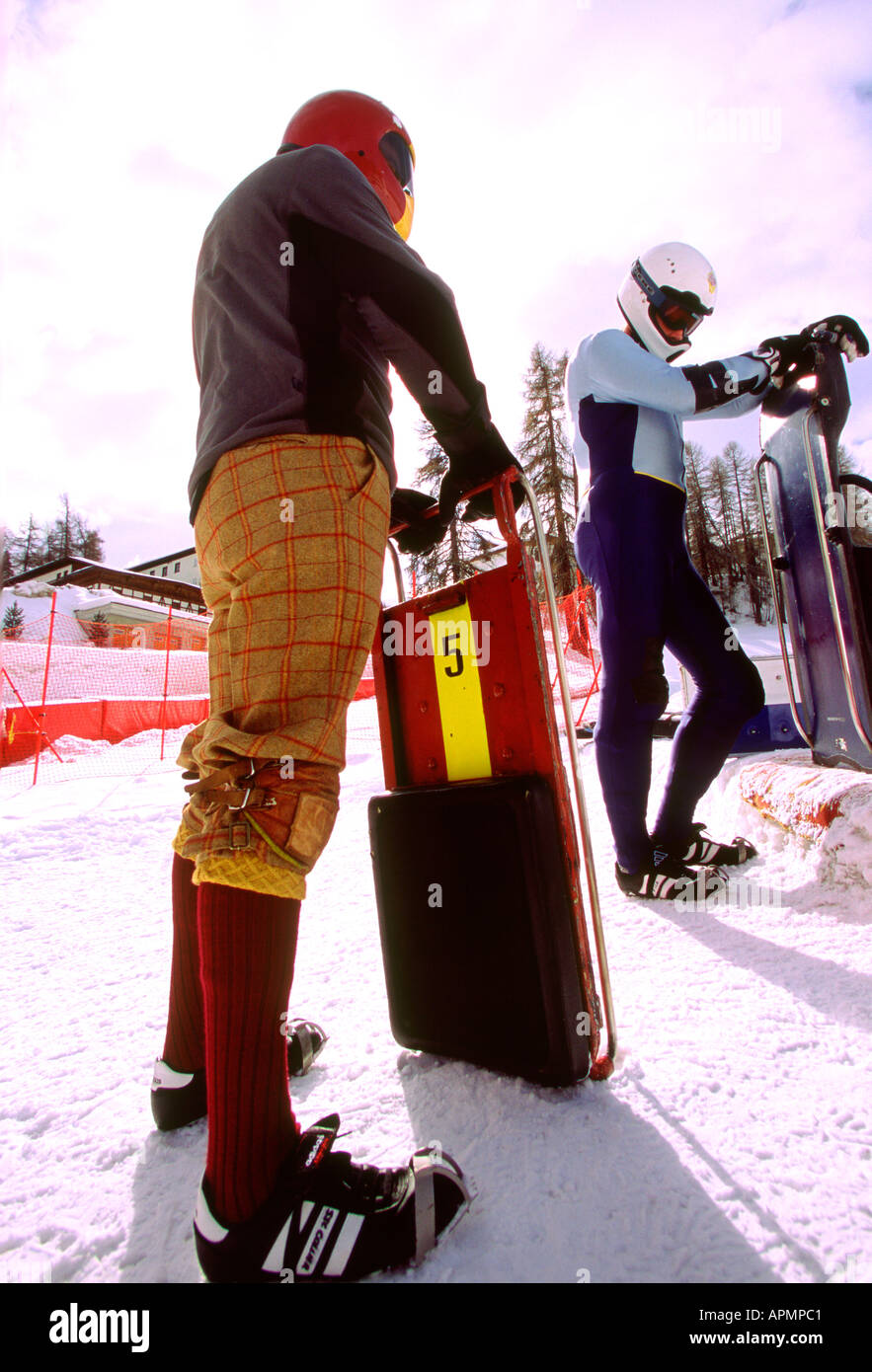 Two sportsmen wait with toboggans on the cresta run in St Moritz Stock Photo