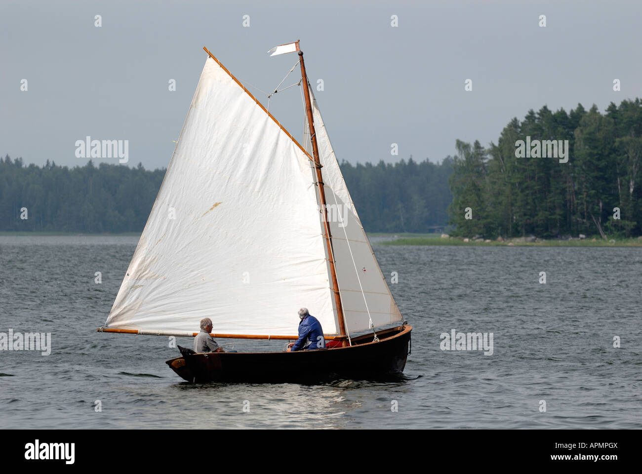 An old couple and a wooden sailing boat in the Porvoo Archipelago