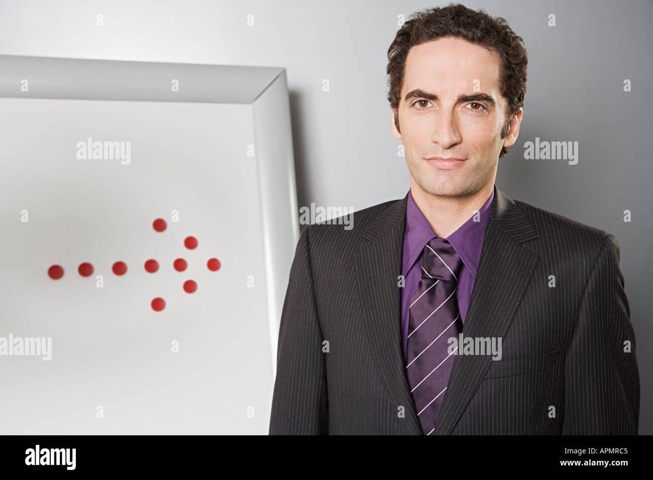 Businessman with arrow on flipchart Stock Photo