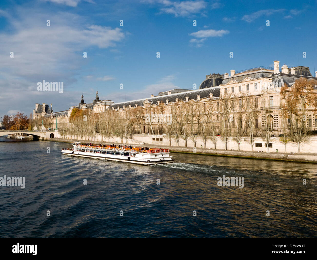 Bateaux Mouches sightseeing cruise boat on the Seine next to the Louvre and Pont du Carrousel Paris France Europe Stock Photo