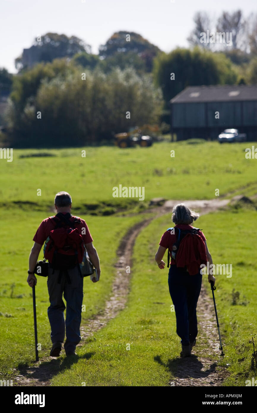 Two walkers in Cotswold countryside in the summer, Bledington, Gloucestershire, UK Stock Photo