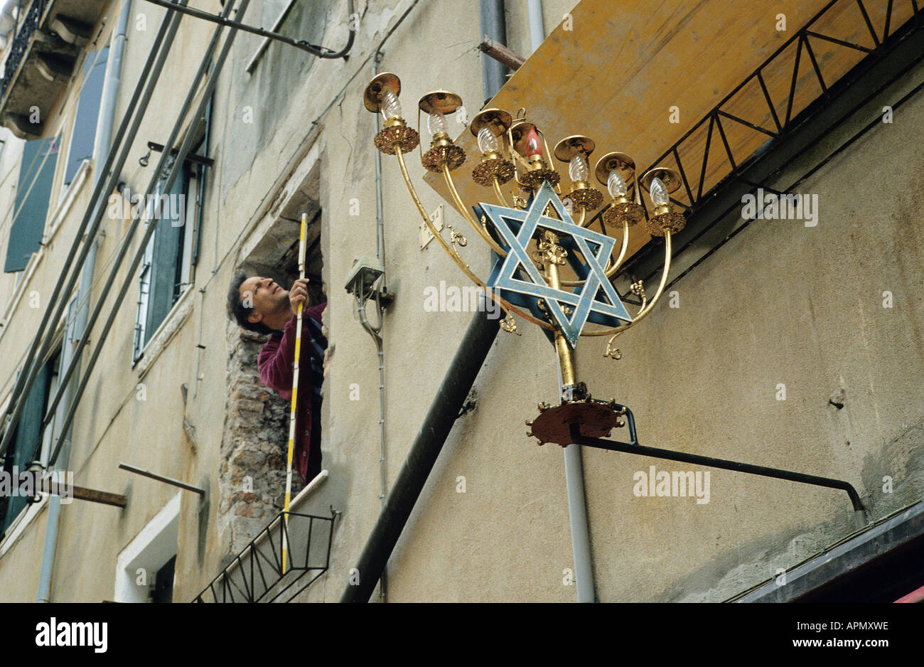 A large Menorah the ceremonial seven branched candlestick and symbol of the Jewish race on the exterior of a building in the Ghetto Nuova area of Venice Stock Photo