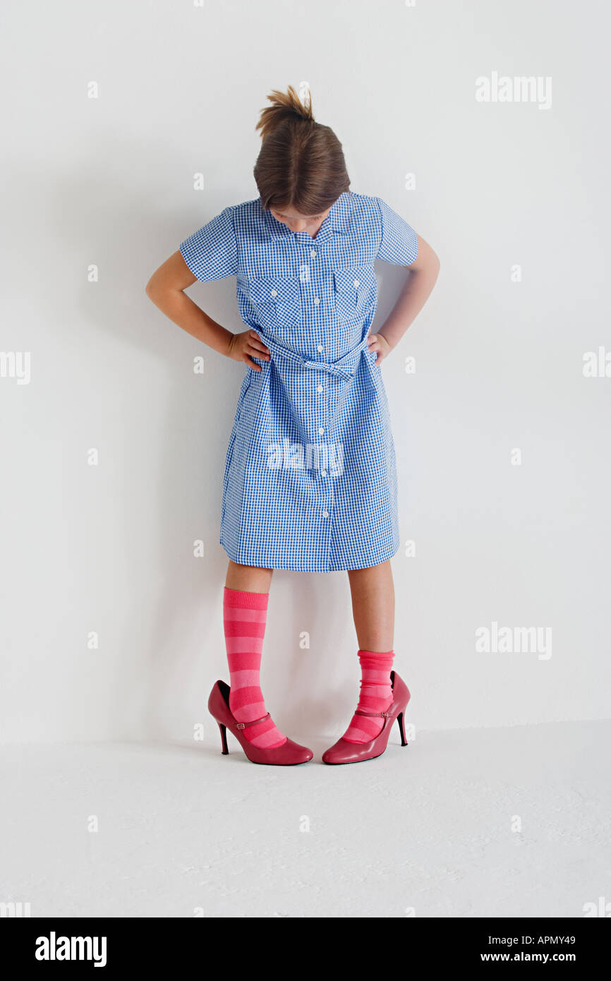 Young girl wearing high heel shoes hires stock photography and images