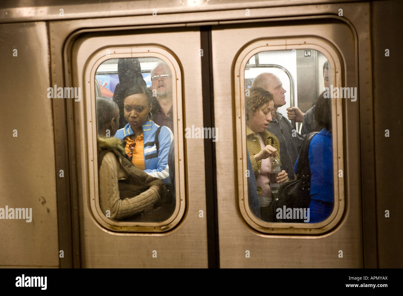 Crowded subway train entering the station.  NYC subway system Stock Photo