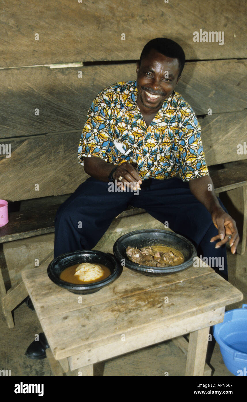 Ghanaian eating grass cutter a large rodent in a bush meat restaurant