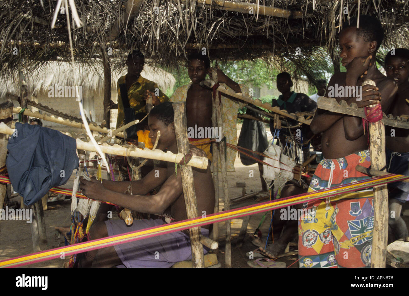 Weavers making traditional kente cloth from locally grown and dyed cotton in Kumasi Ghana Stock Photo