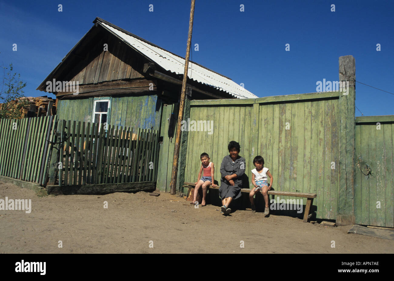Buryat mother and her family outside their home on Lake Baikal Siberia Russia Stock Photo