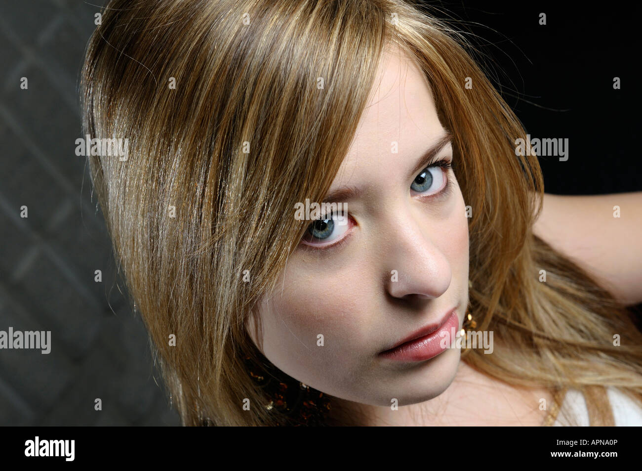 Face of young girl with sandy blond hair and makeup looking up Stock ...