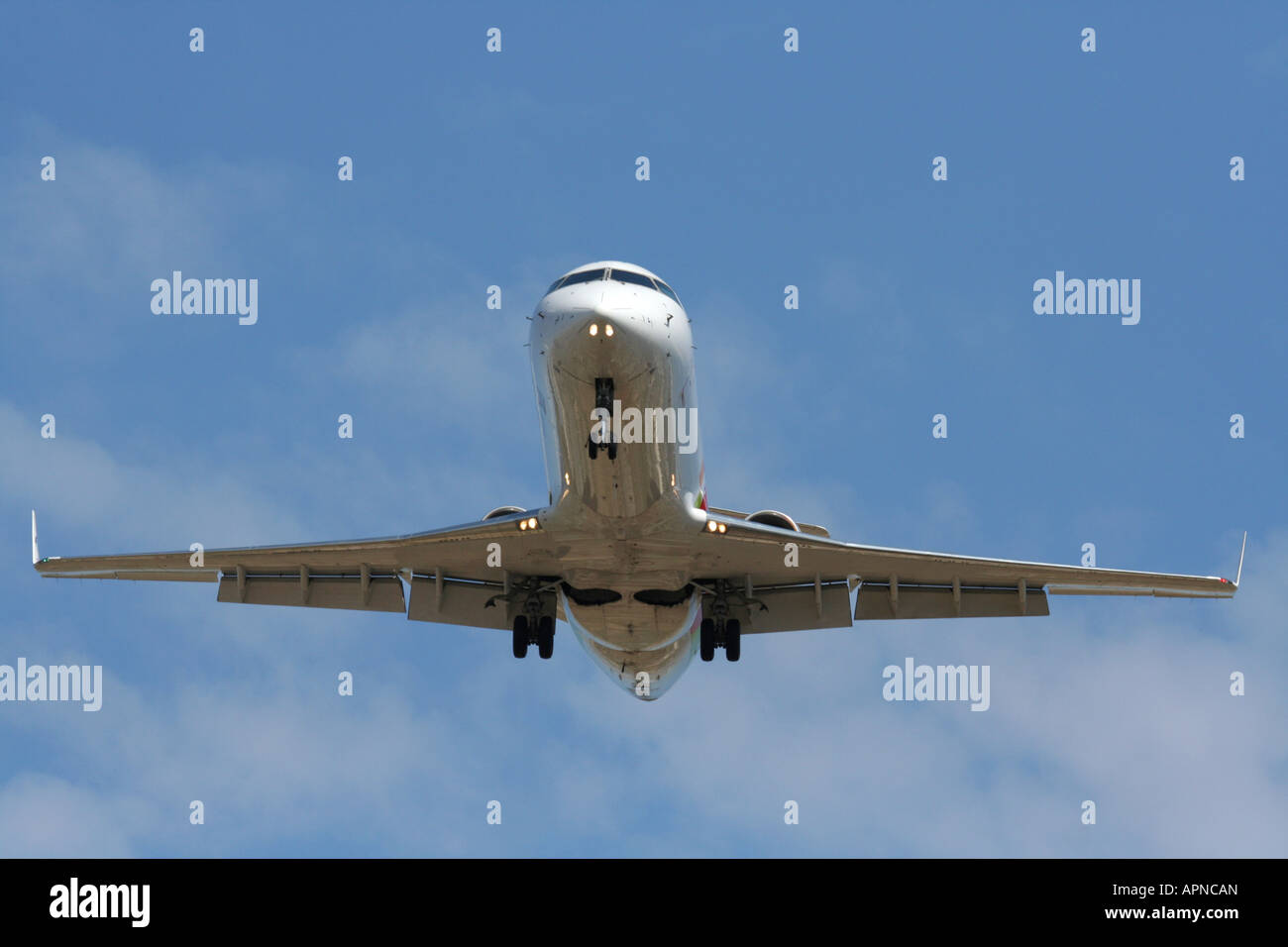 Air travel. CRJ200 regional airliner on approach for landing. Proprietary details deleted. Stock Photo