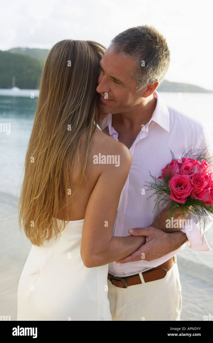 Newlyweds hugging on beach, St John, US Virgin Islands, USA Stock Photo