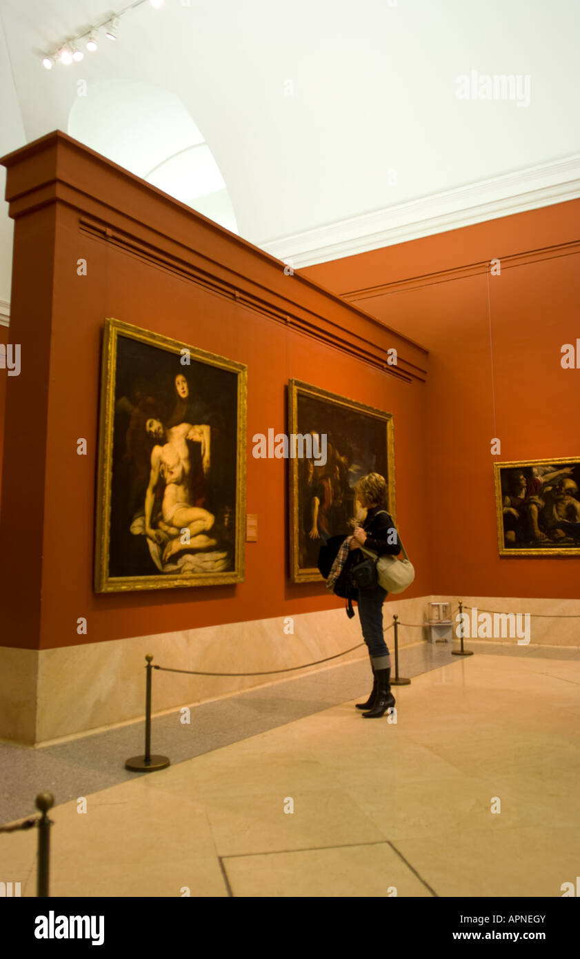 Woman enjoying learning from Daniele Crespi painting called La Pieta from 1623 in the spacious Prado Museum in Madrid Spain Stock Photo