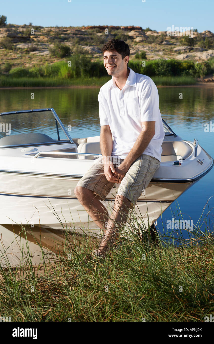 Young man sitting on motorboat Stock Photo - Alamy