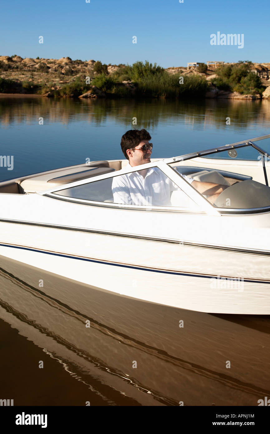 Young man in motorboat Stock Photo - Alamy