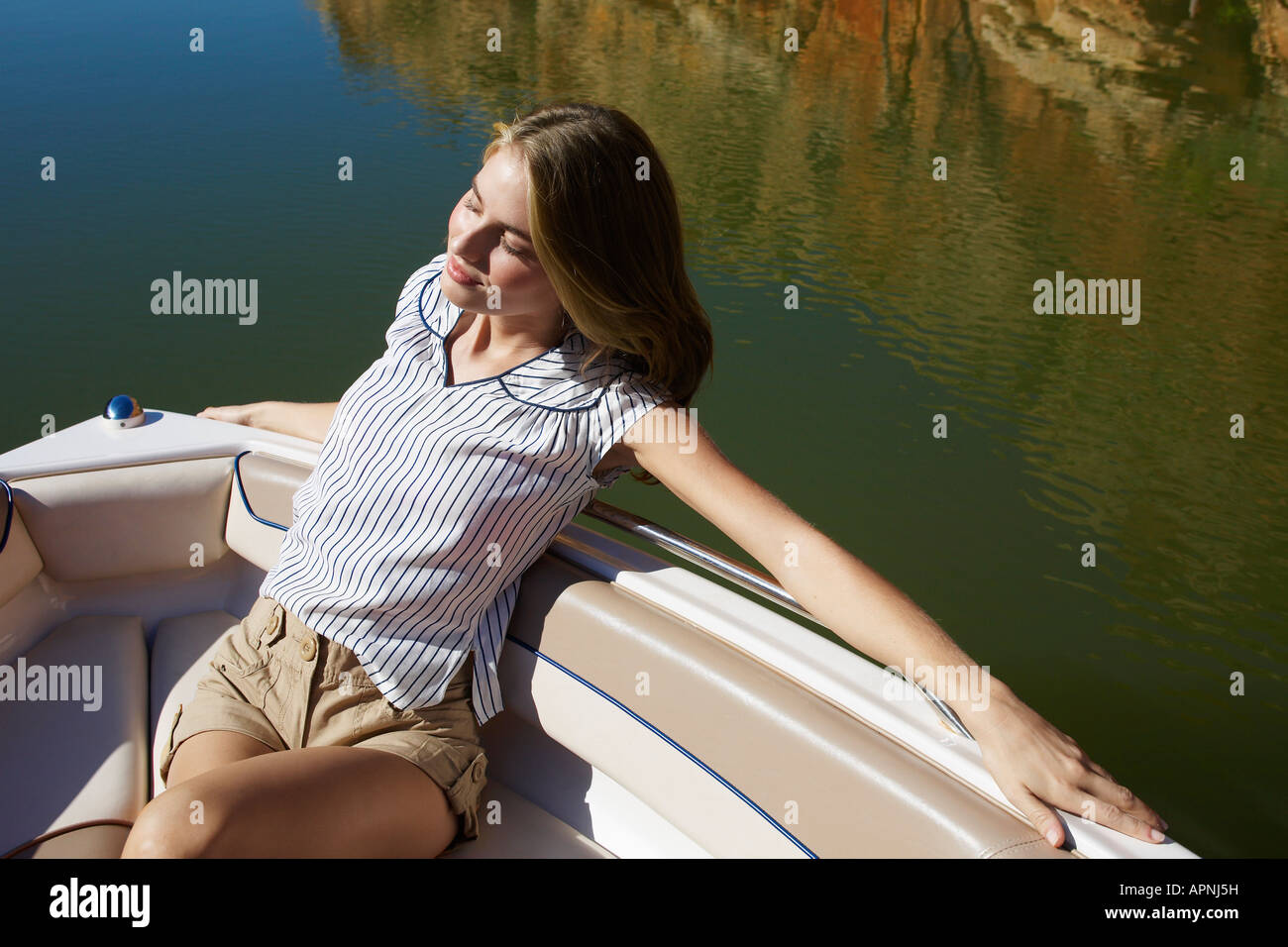 Young woman relaxing in boat (high angle view) Stock Photo