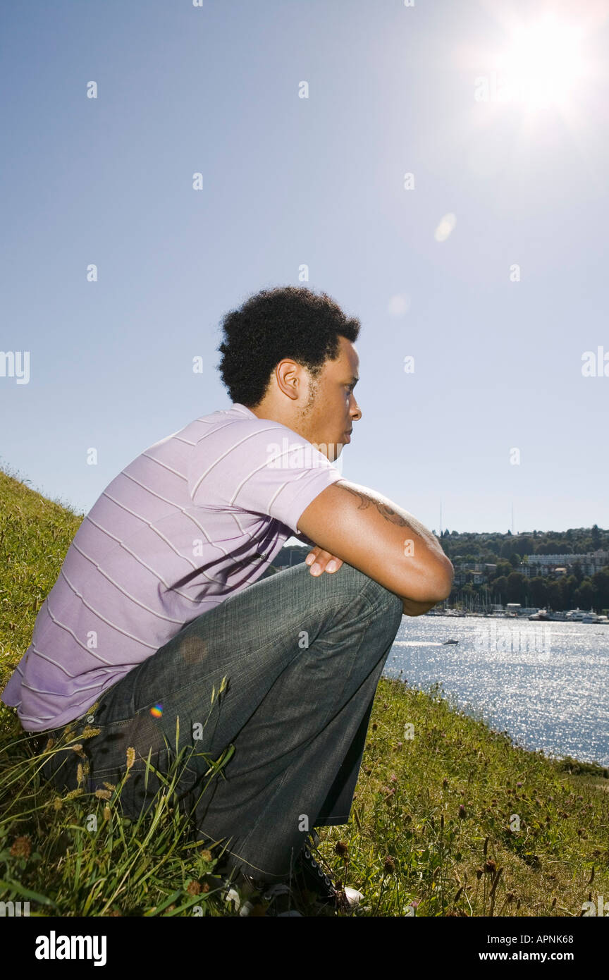 Young man sitting and thinking Stock Photo