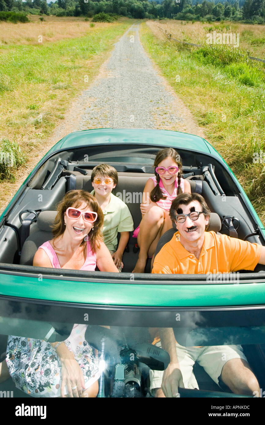 Playful family in convertible Stock Photo