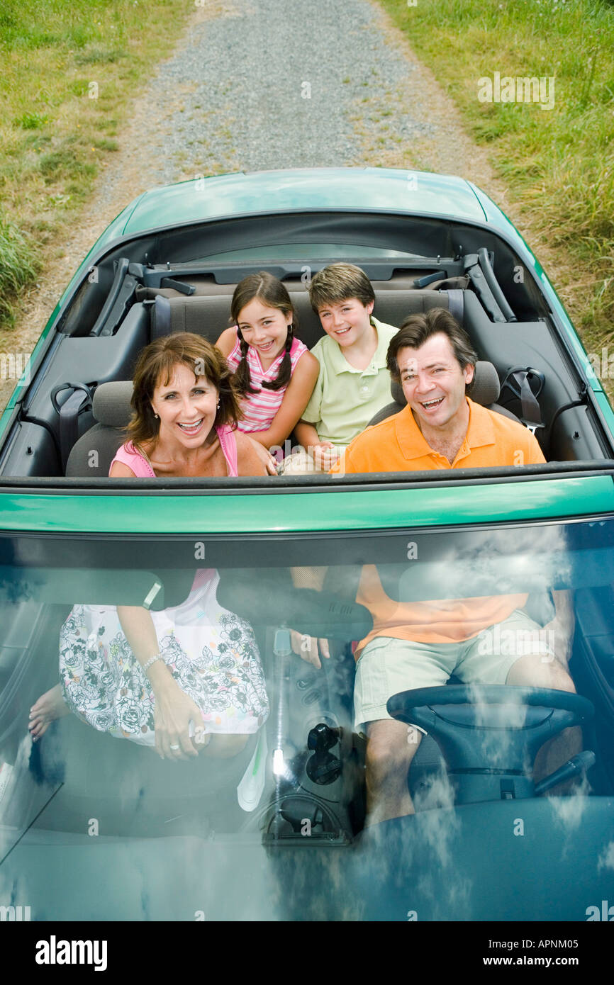 Family in convertible with top down Stock Photo
