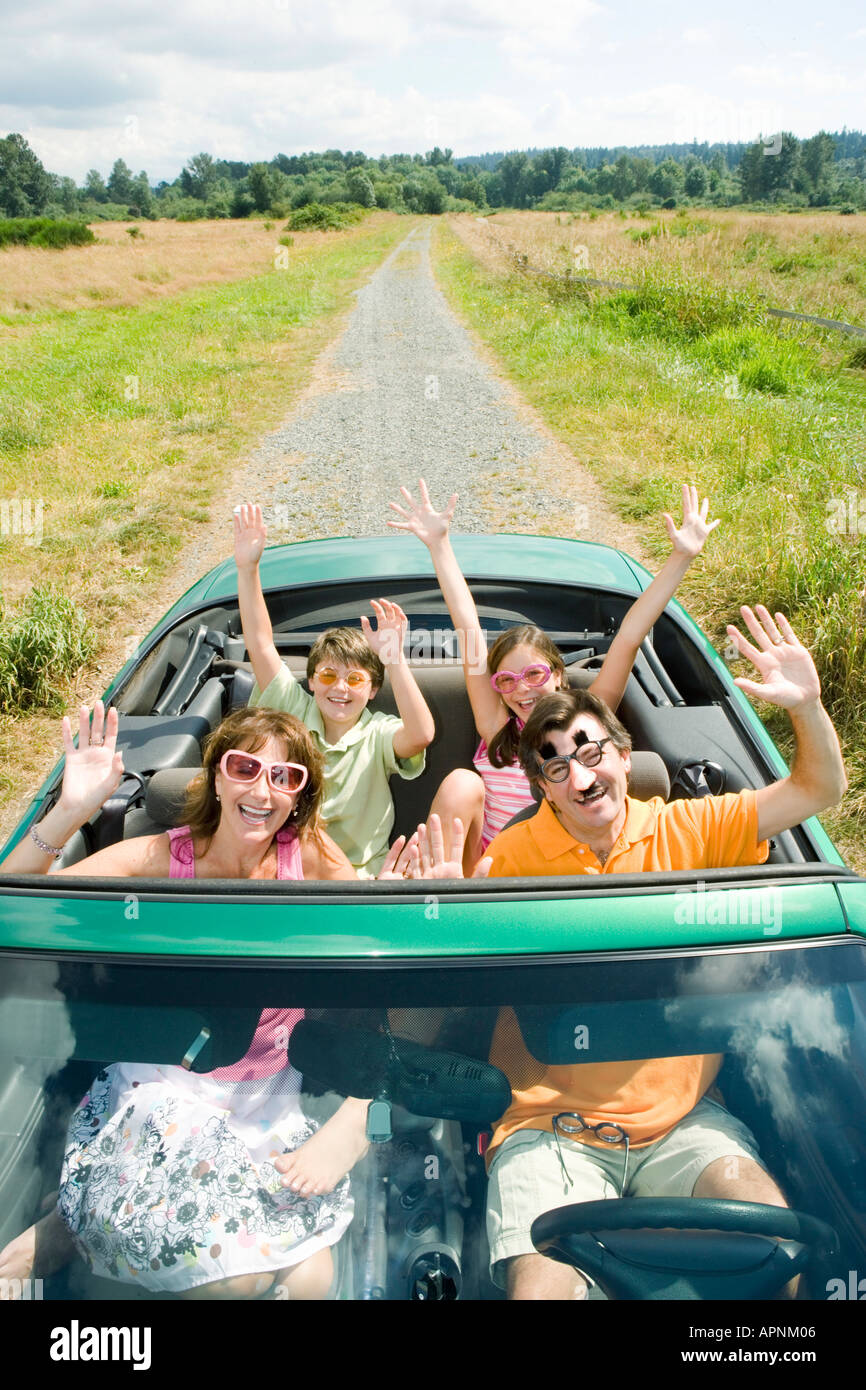 Enthusiastic silly family in convertible Stock Photo