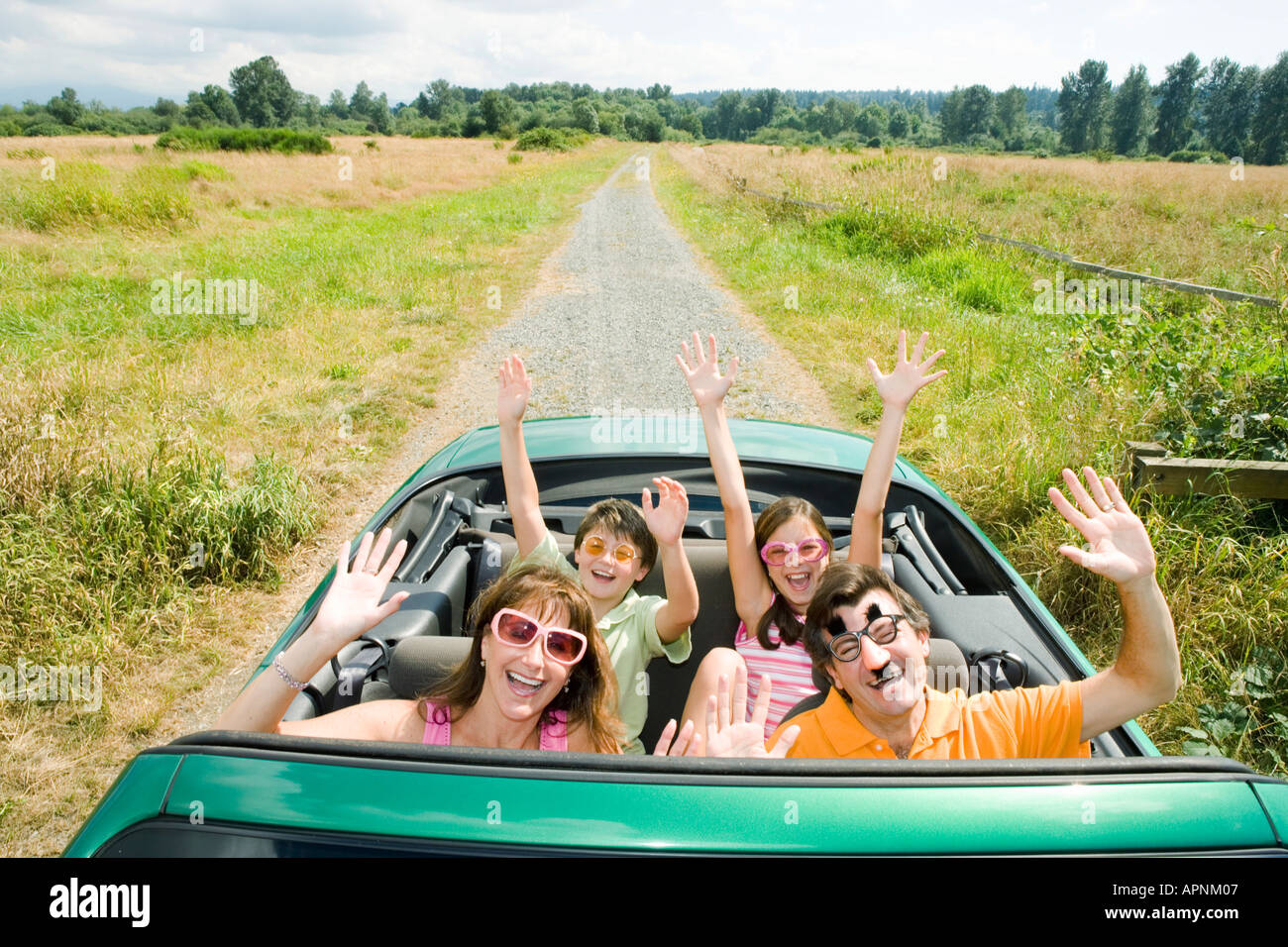 Enthusiastic silly family in convertible Stock Photo