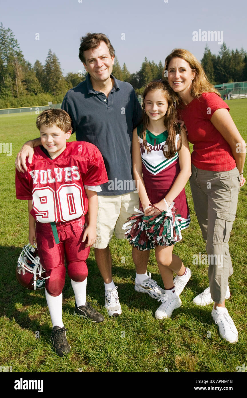 Football player and cheerleader with parents Stock Photo