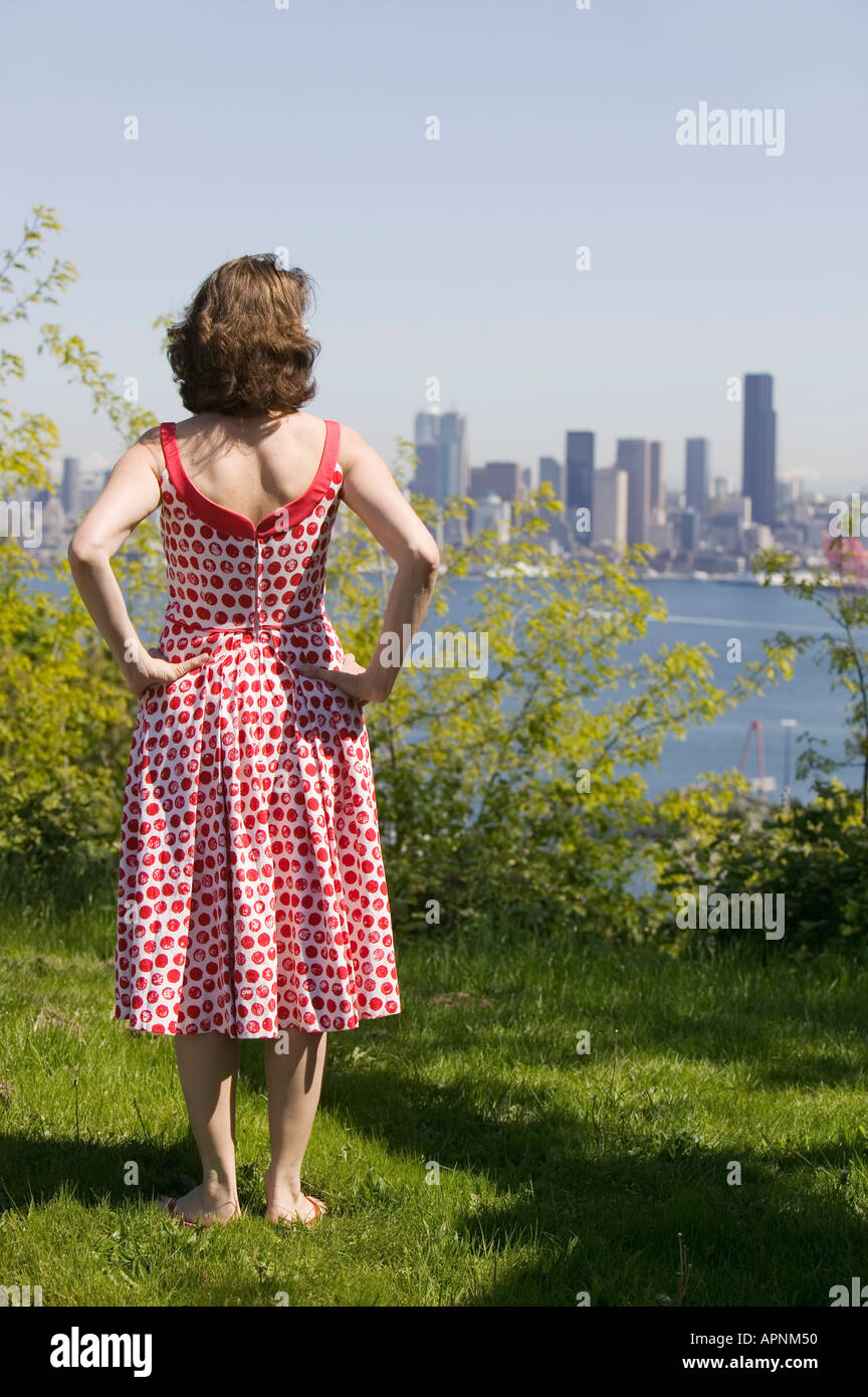 Woman looking at city skyline Stock Photo