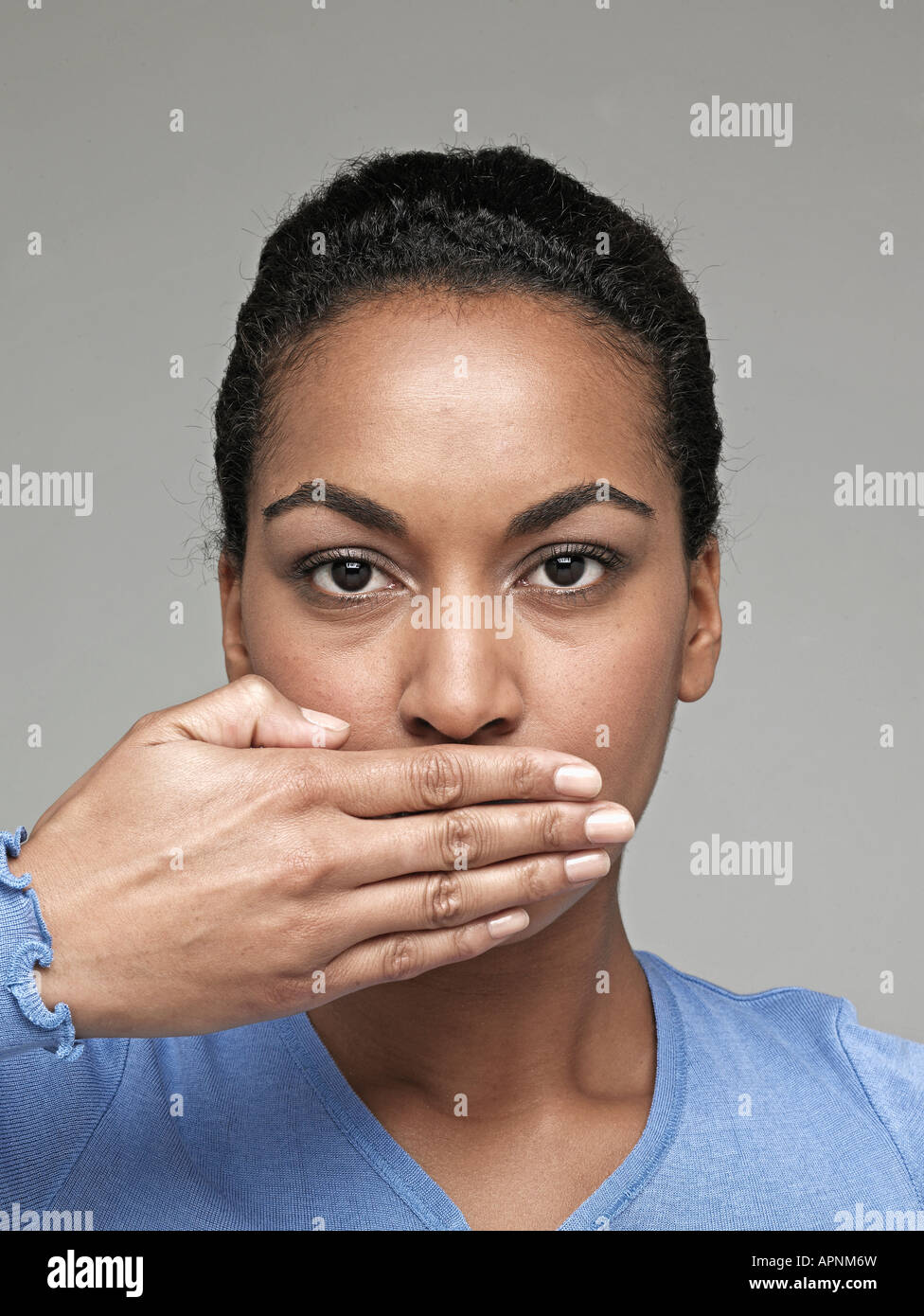 Young woman with hand over mouth Stock Photo Alamy
