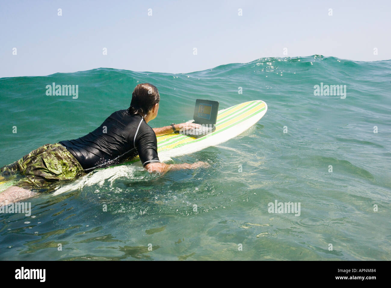 Man using laptop while surfing Stock Photo - Alamy