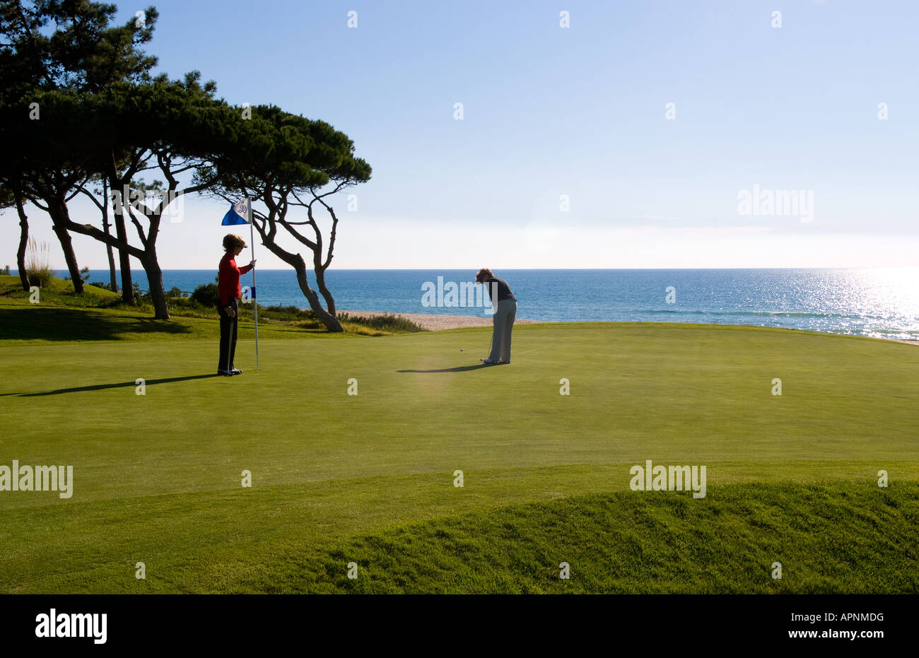 Woman and man golfing on the expensive Ocean Club in the exclusive
