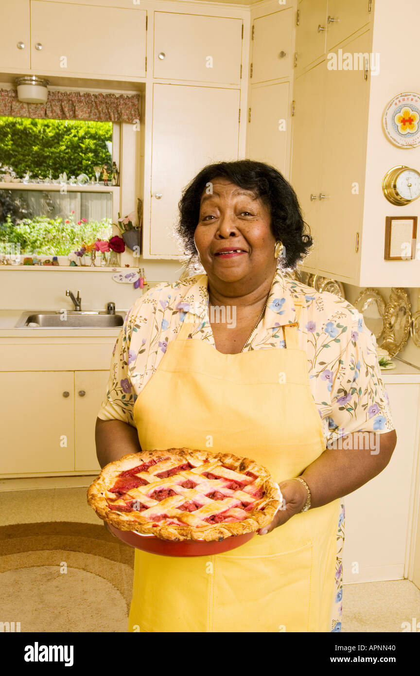 Portrait of woman holding homemade pie Stock Photo